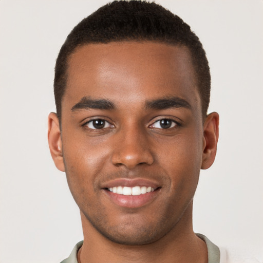 Joyful black young-adult male with short  brown hair and brown eyes
