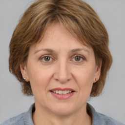 Joyful white adult female with medium  brown hair and grey eyes