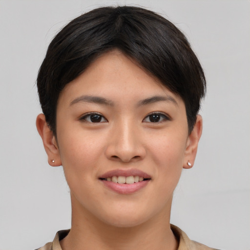 Joyful asian young-adult female with short  brown hair and brown eyes