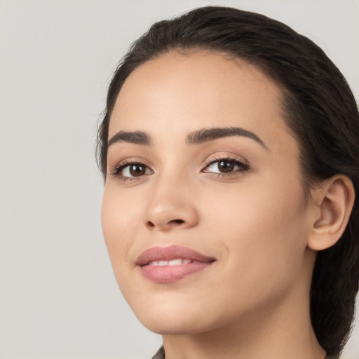 Joyful white young-adult female with long  black hair and brown eyes