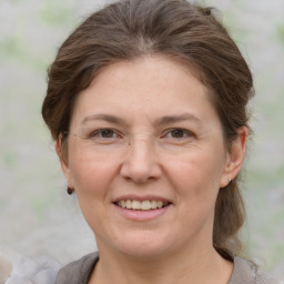 Joyful white adult female with short  brown hair and grey eyes