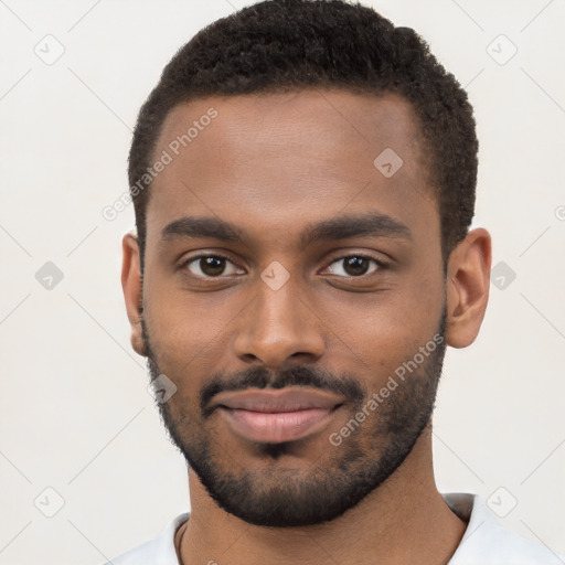 Joyful black young-adult male with short  brown hair and brown eyes