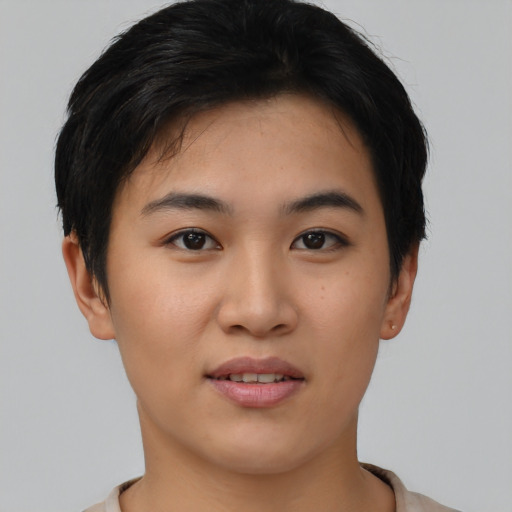 Joyful asian young-adult female with short  black hair and brown eyes