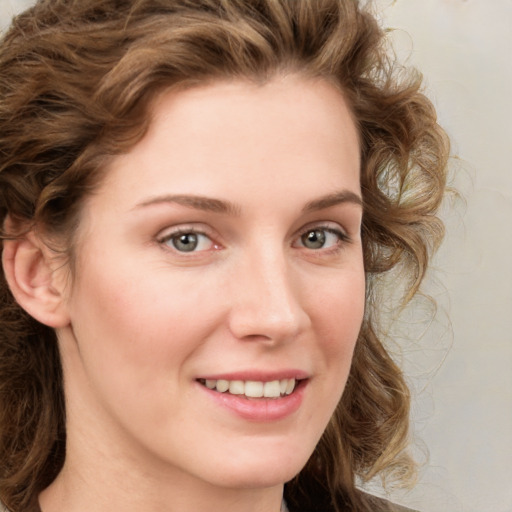 Joyful white young-adult female with medium  brown hair and green eyes