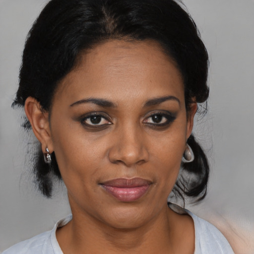 Joyful black young-adult female with medium  black hair and brown eyes