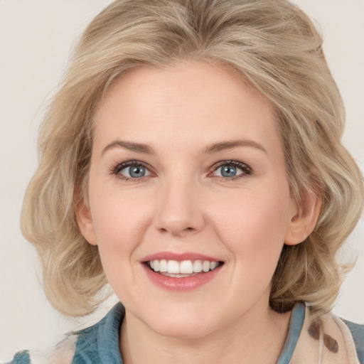 Joyful white young-adult female with medium  blond hair and blue eyes