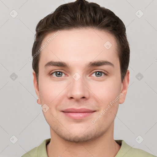 Joyful white young-adult male with short  brown hair and grey eyes