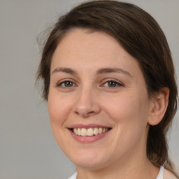 Joyful white young-adult female with medium  brown hair and brown eyes