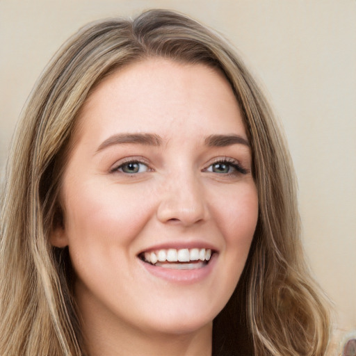 Joyful white young-adult female with long  brown hair and green eyes