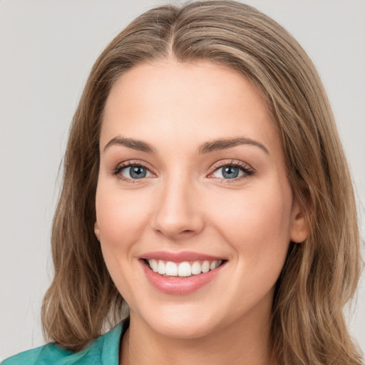 Joyful white young-adult female with long  brown hair and green eyes