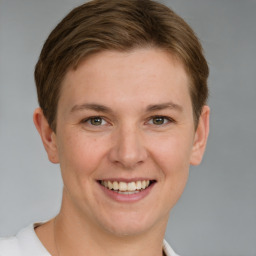 Joyful white young-adult female with short  brown hair and grey eyes