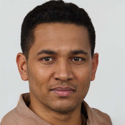 Joyful latino young-adult male with short  brown hair and brown eyes