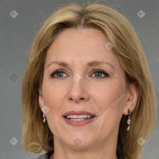 Joyful white adult female with medium  brown hair and blue eyes