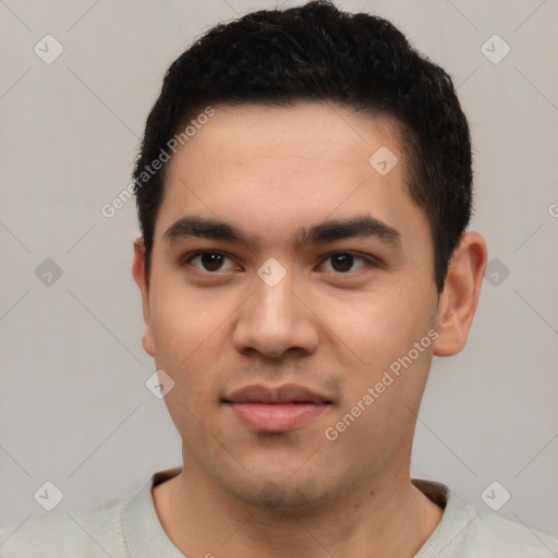 Joyful latino young-adult male with short  black hair and brown eyes