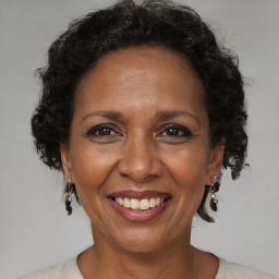 Joyful black adult female with medium  brown hair and brown eyes