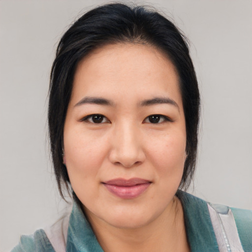 Joyful asian young-adult female with medium  black hair and brown eyes