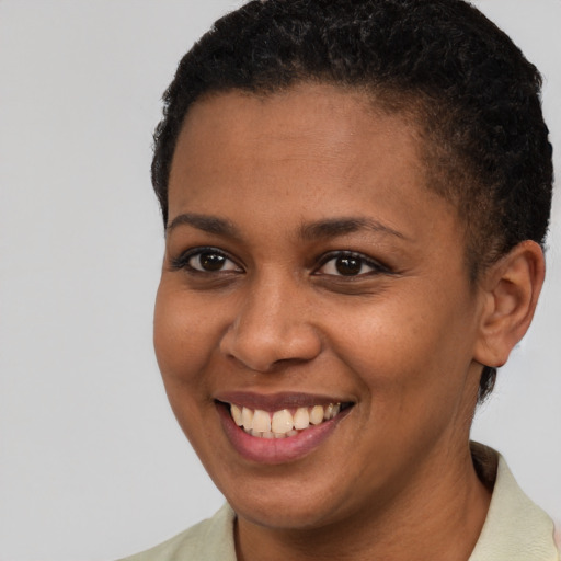 Joyful black young-adult female with short  brown hair and brown eyes