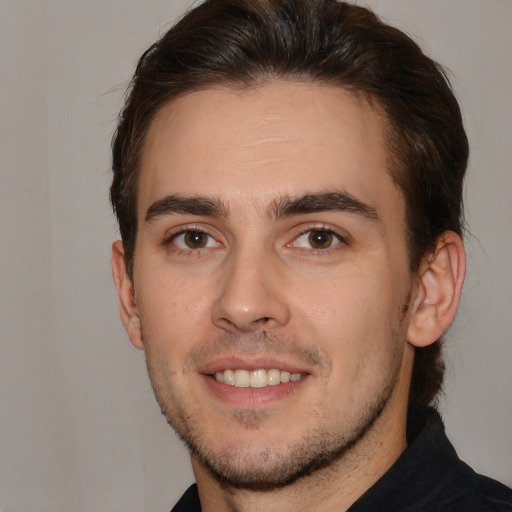 Joyful white young-adult male with short  brown hair and brown eyes