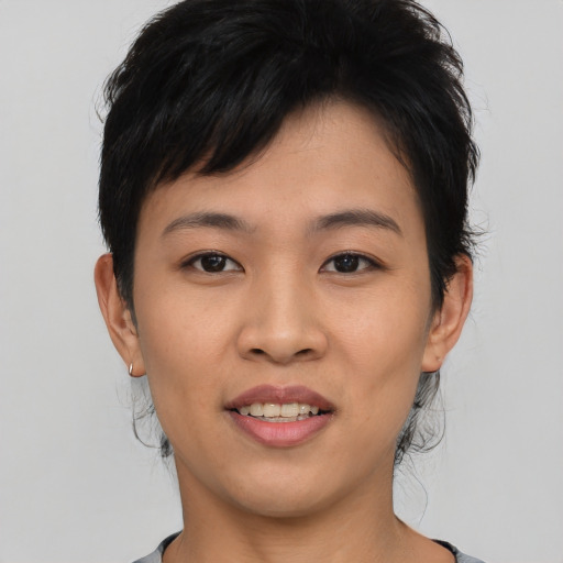Joyful asian young-adult female with short  black hair and brown eyes