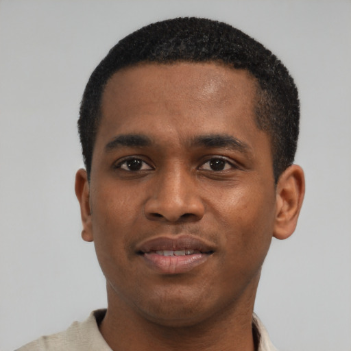 Joyful black young-adult male with short  black hair and brown eyes