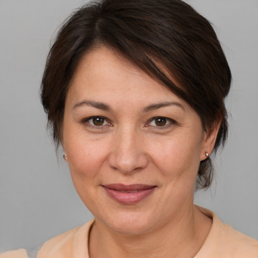 Joyful white adult female with medium  brown hair and brown eyes