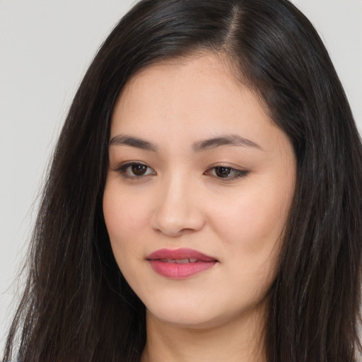 Joyful asian young-adult female with long  black hair and brown eyes