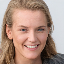 Joyful white young-adult female with long  brown hair and blue eyes