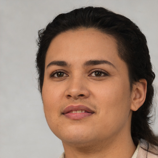 Joyful latino young-adult female with short  black hair and brown eyes