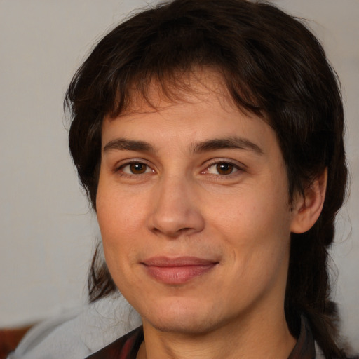 Joyful white adult female with medium  brown hair and brown eyes