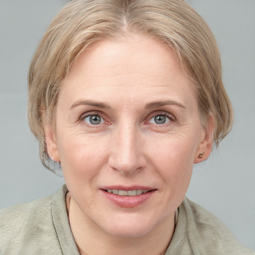 Joyful white adult female with medium  brown hair and blue eyes