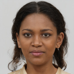 Joyful black young-adult female with medium  brown hair and brown eyes