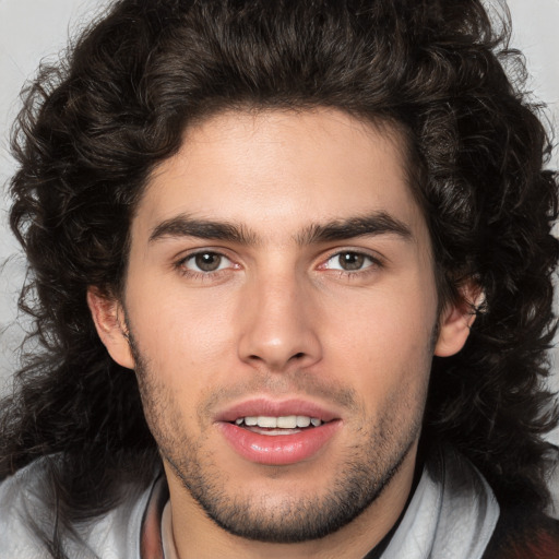 Joyful white young-adult male with medium  brown hair and brown eyes