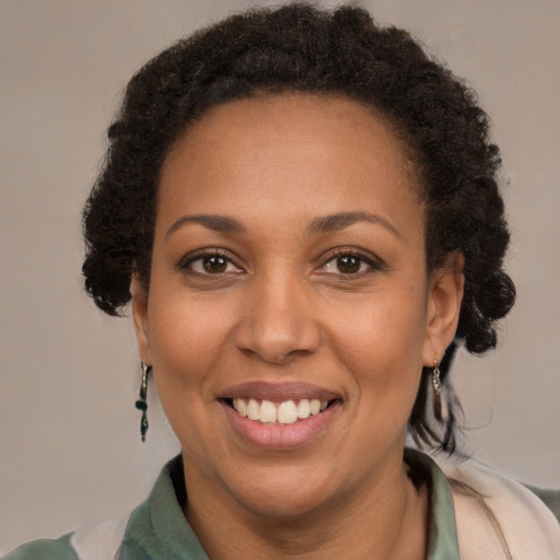 Joyful black adult female with short  brown hair and brown eyes