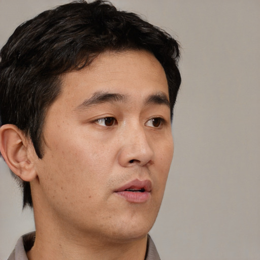 Neutral asian young-adult male with short  brown hair and brown eyes