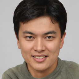 Joyful asian young-adult male with short  brown hair and brown eyes