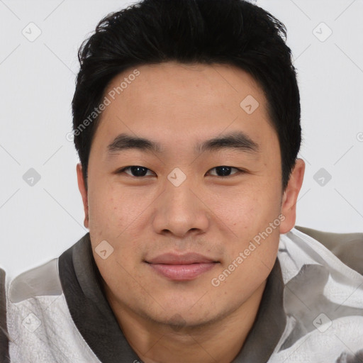 Joyful asian young-adult male with short  black hair and brown eyes