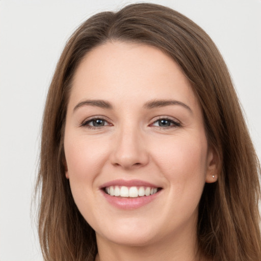 Joyful white young-adult female with long  brown hair and grey eyes