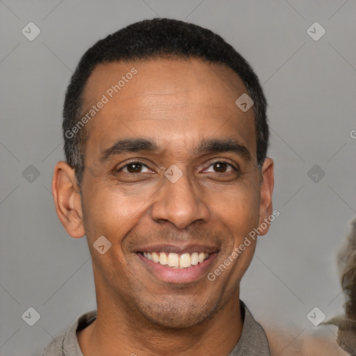 Joyful black adult male with short  black hair and brown eyes