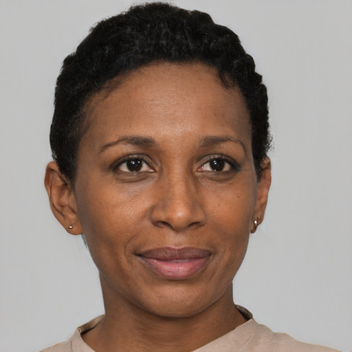 Joyful black adult female with short  black hair and brown eyes
