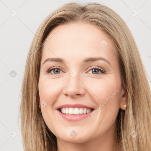 Joyful white young-adult female with long  brown hair and green eyes