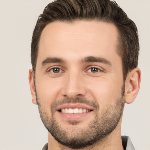 Joyful white young-adult male with short  brown hair and brown eyes