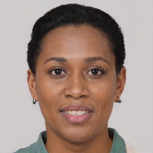 Joyful black adult female with short  brown hair and brown eyes