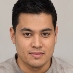 Joyful latino young-adult male with short  brown hair and brown eyes