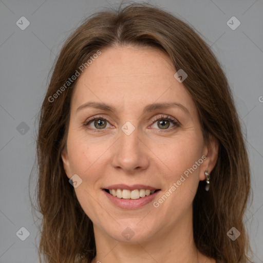 Joyful white adult female with long  brown hair and grey eyes