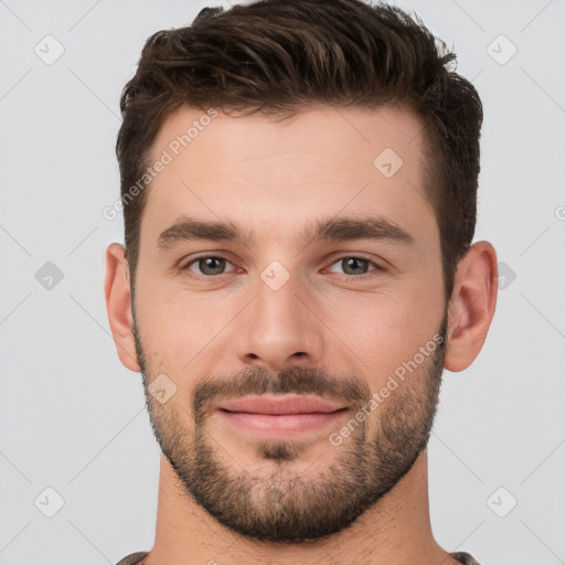 Joyful white young-adult male with short  brown hair and brown eyes