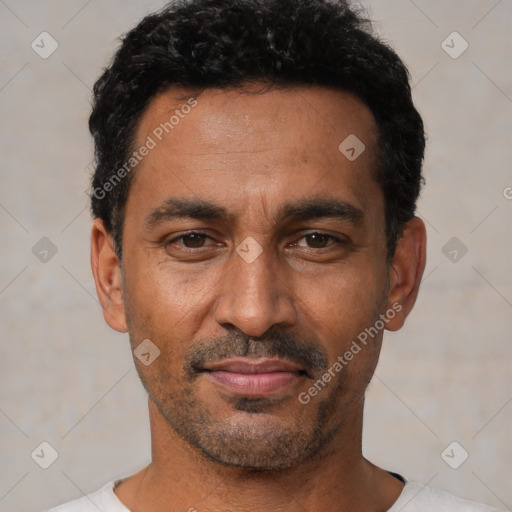 Joyful latino adult male with short  black hair and brown eyes