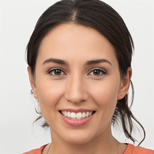 Joyful white young-adult female with medium  brown hair and brown eyes