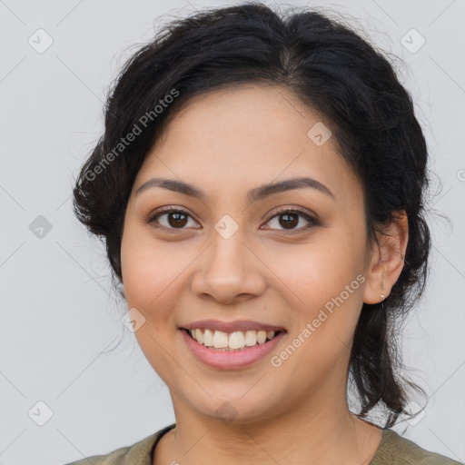 Joyful latino young-adult female with medium  brown hair and brown eyes