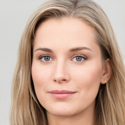 Joyful white young-adult female with long  brown hair and blue eyes