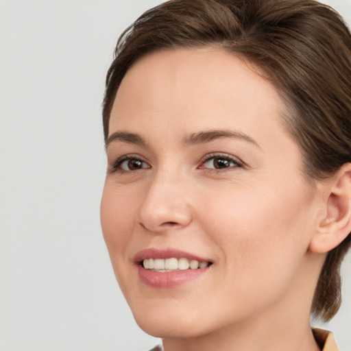 Joyful white young-adult female with medium  brown hair and brown eyes